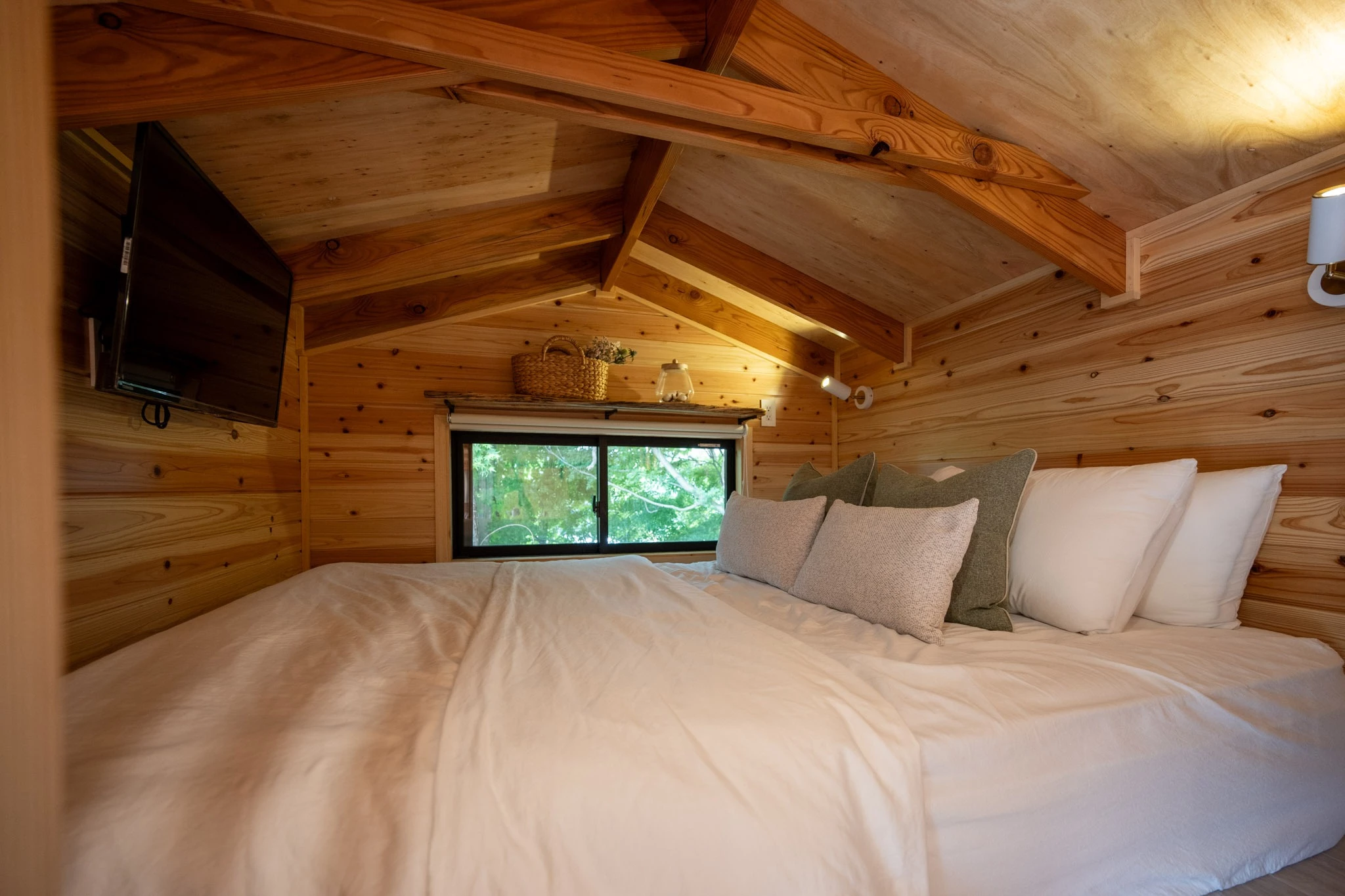 The Nozawa's bedroom is shown furnished with a double bed and a wall-mounted TV