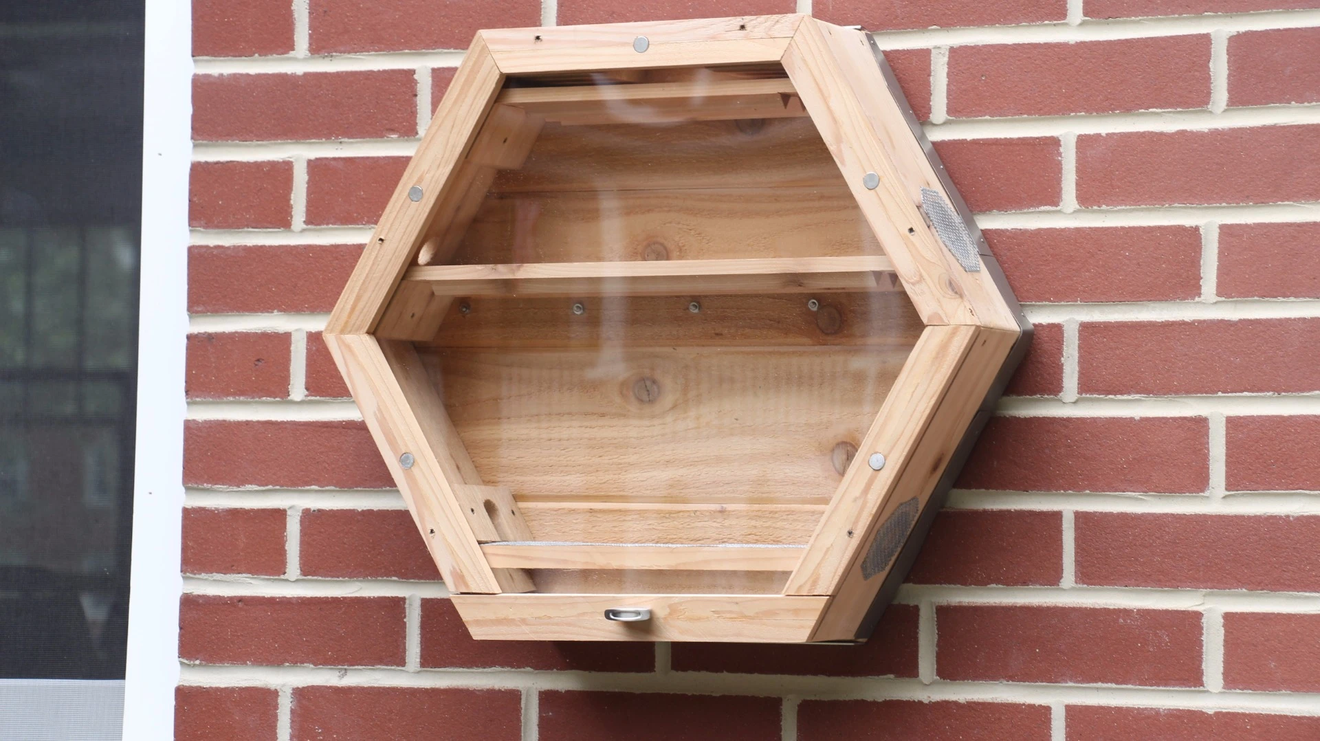The BEEcosystem attaches to a wall using a provided wall bracket