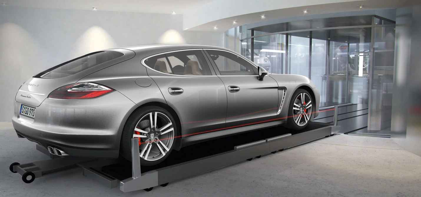 Robotic arms guide your car into one of the three glass elevators (Image: Porsche Design)