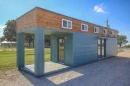 The container home is constructed from a single shipping container that has been extended in height to make room for two lofts