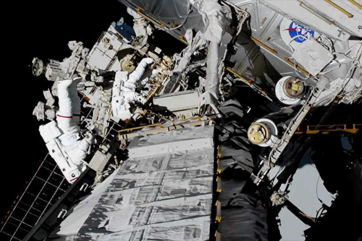 NASA spacewalkers Christina Koch (foreground, suit with red stripe) and Jessica Meir (suit with no stripes) replaced a failed battery charge-discharge unit with a new one during a 7-hour, 17-minute spacewalk