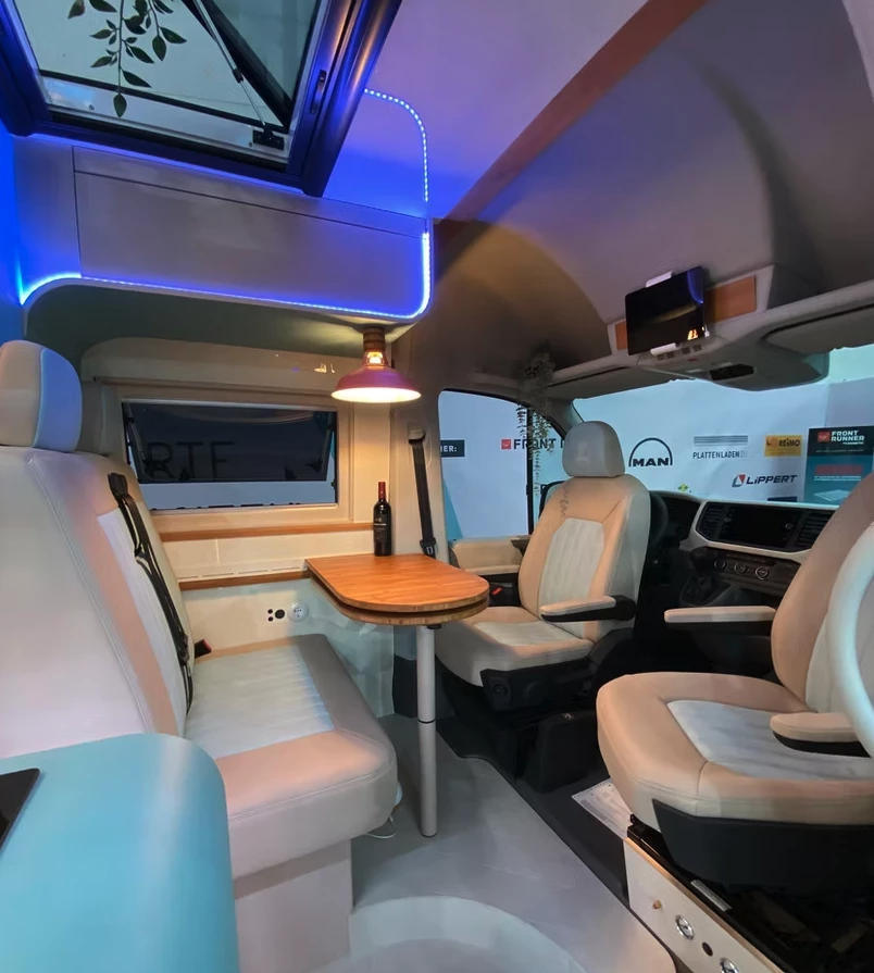 In the dining lounge, Camper Schmiede has installed a fixed version of a hanging dining room lamp for a homey feel that doesn't swing around while moving