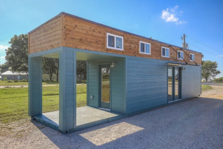 The container home is constructed from a single shipping container that has been extended in height to make room for two lofts