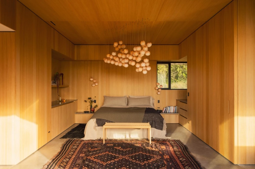 Cedar furnishings and cabinetry fill the master bedroom