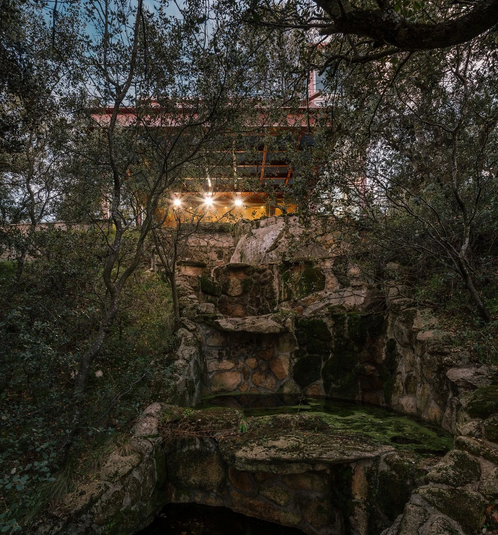 A section of the Hidden Pavilion cantilevers over a small waterfall