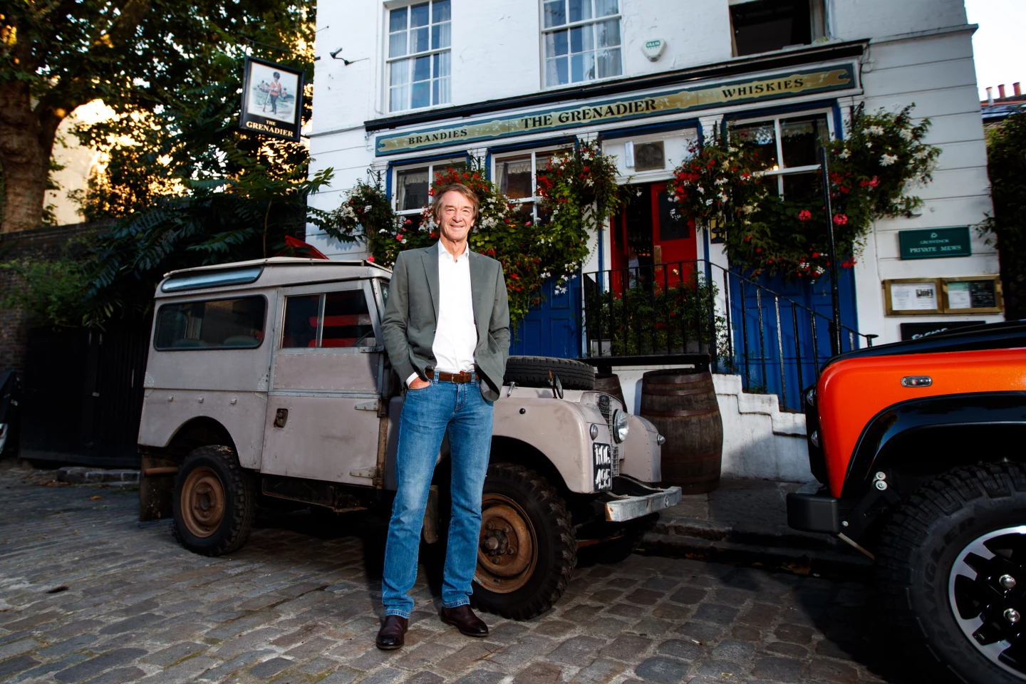 The Ineos Grenadier is less a shameless Defender copycat and more a living homage. When Land Rover retired the original Defender back in 2016, Sir Jim Ratcliffe, a self-described adventurer and Land Rover fan, tried to buy the Defender tooling to keep the Defender tradition alive but Land Rover denied his overtures. That's Jim with his Land Rover pictured. Instead of giving up, like any reasonable man (thx GBS), Jim built a new company with which to replace the chasm left in the marketplace.