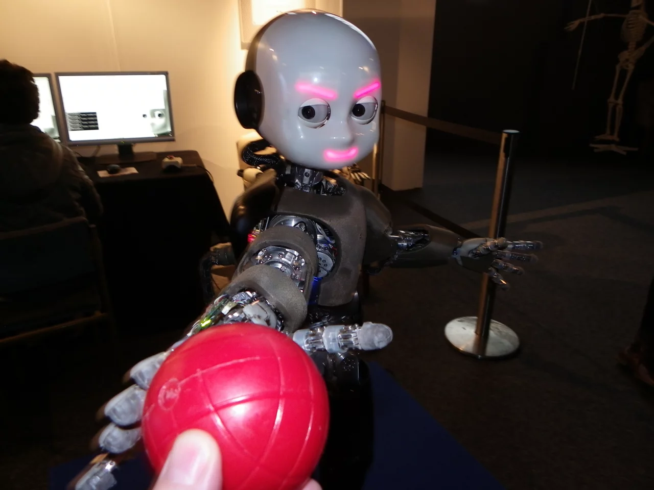 iCub can recognize, reach out for, and take familiar objects, emoting all the way (Photo: Gizmag)