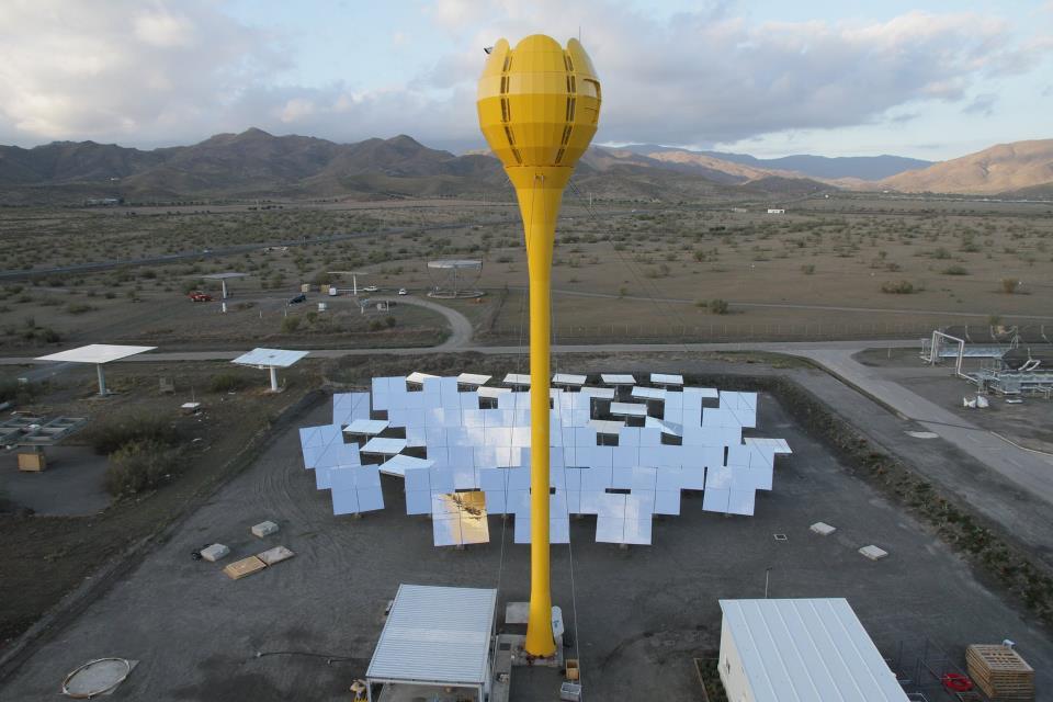 The system incorporates a central tulip-like tower, surrounded by an array of sun-tracking mirrors on the ground
