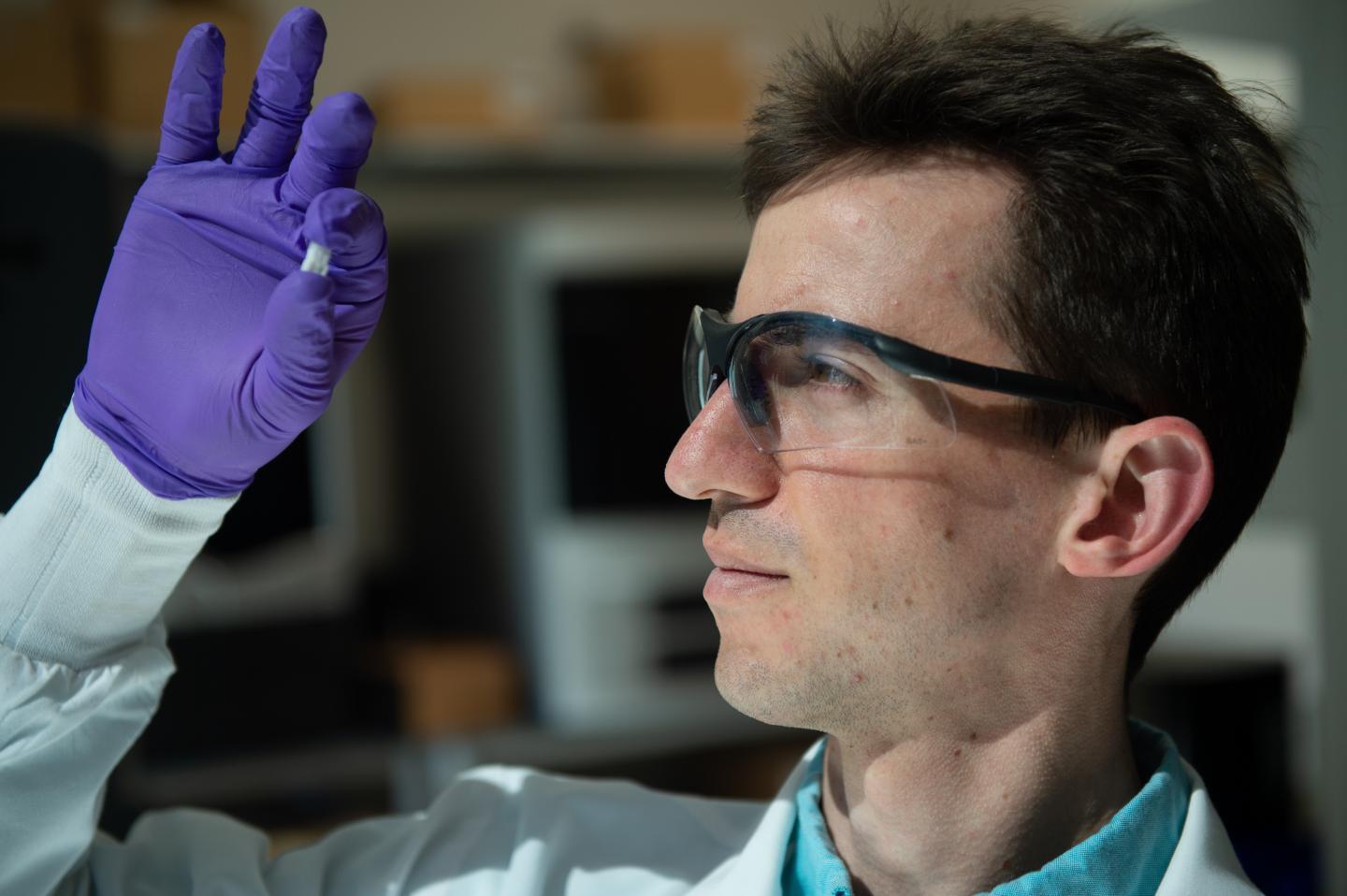 Sean Bittner examines a sample of the material