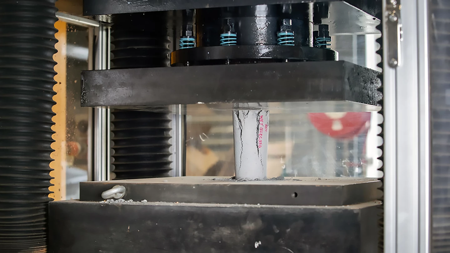 Concrete sample undergoing strength testing