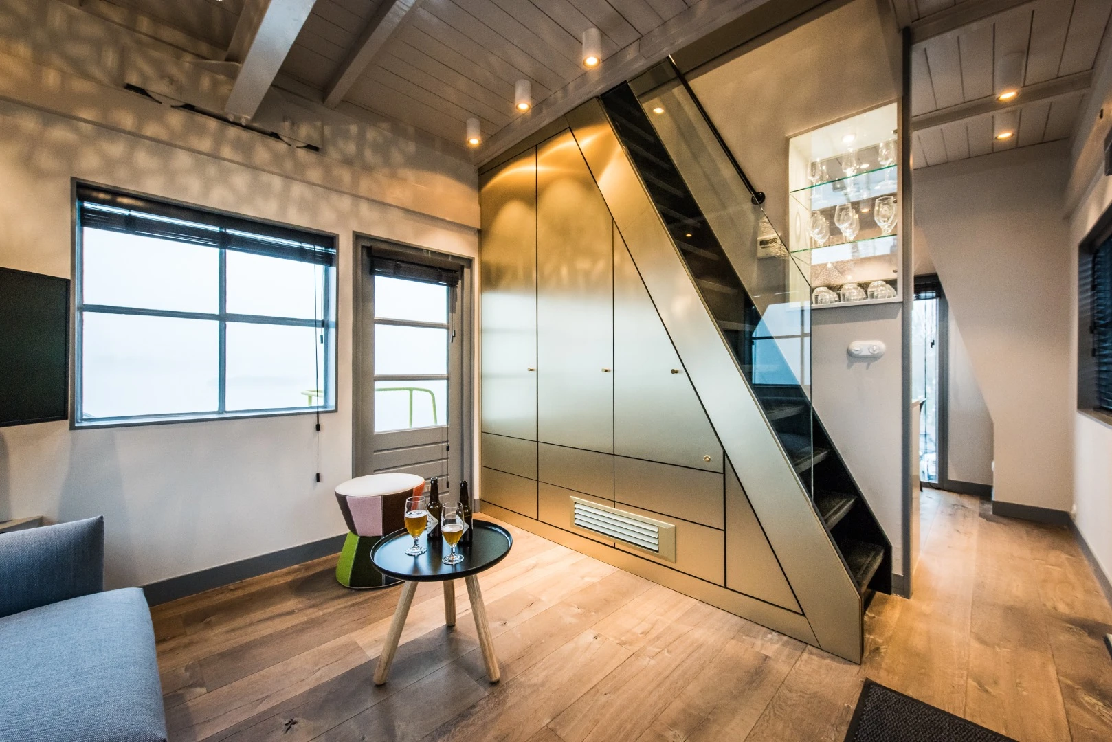 The Yays – Crane Apartment's living room, with storage-integrated staircase