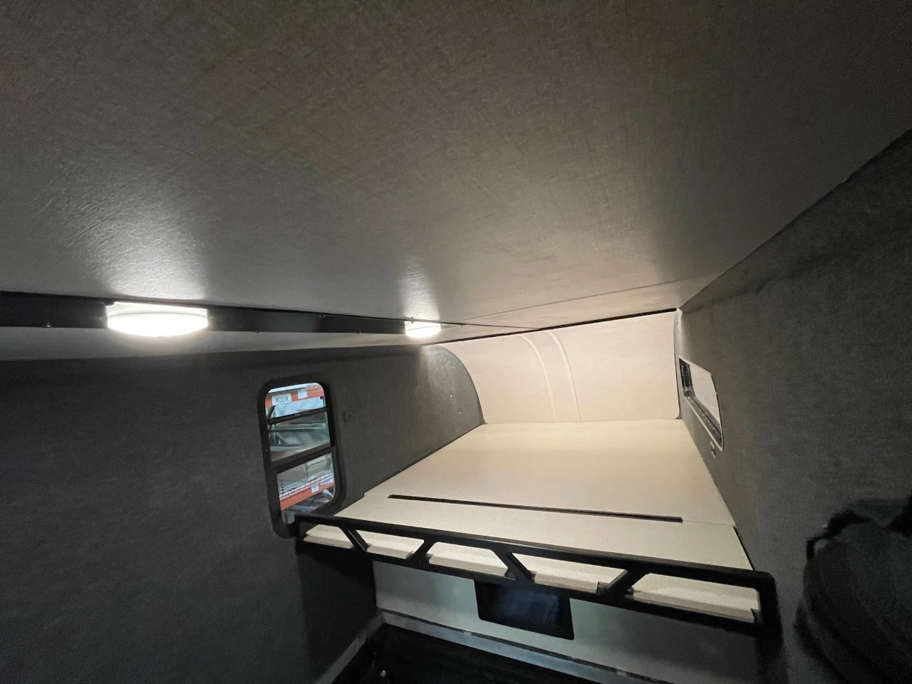 High Altitude keeps weight and price down with a DIY interior that includes only basics like lighting and a sleeper platform