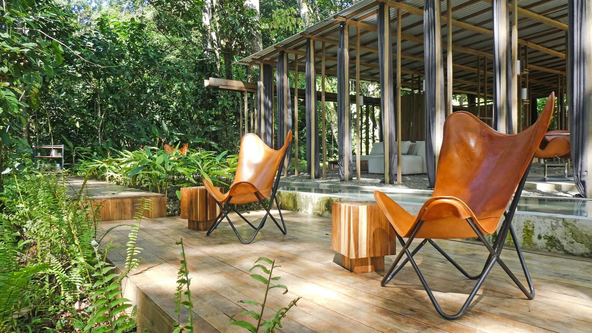The Open Jungle House includes a deck area outside, next to its pool