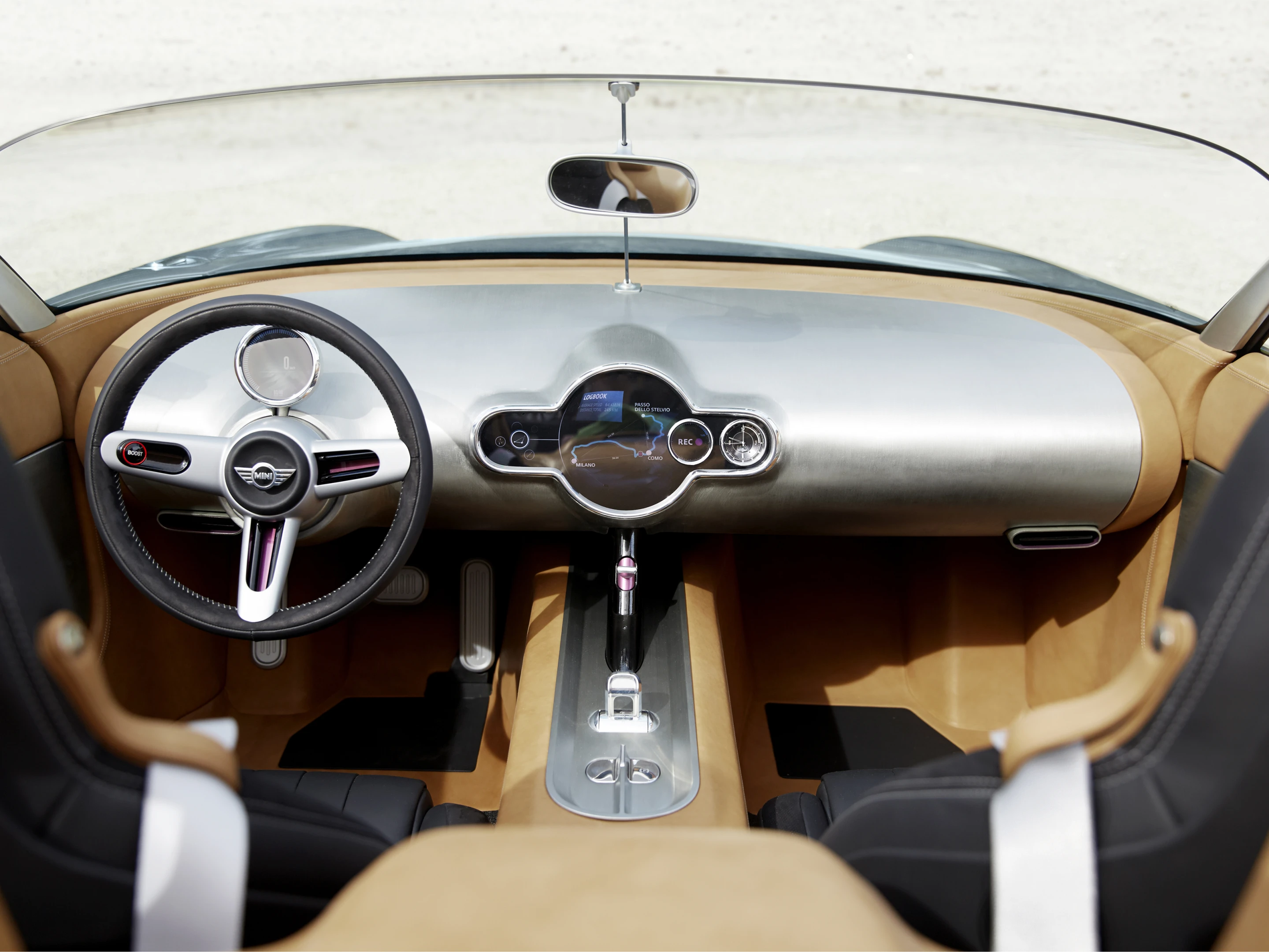 The cockpit features a bare aluminum dashboard with the most minimal of gaugework and dials
