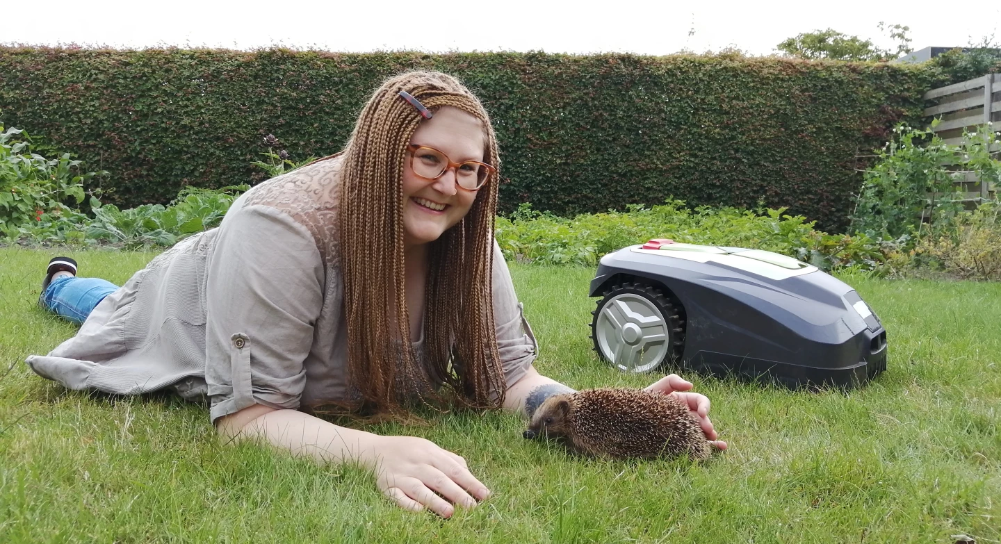 Dr. Sophie Lund Rasmussen (aka "Dr. Hedgehog") with a hedgehog and a mower