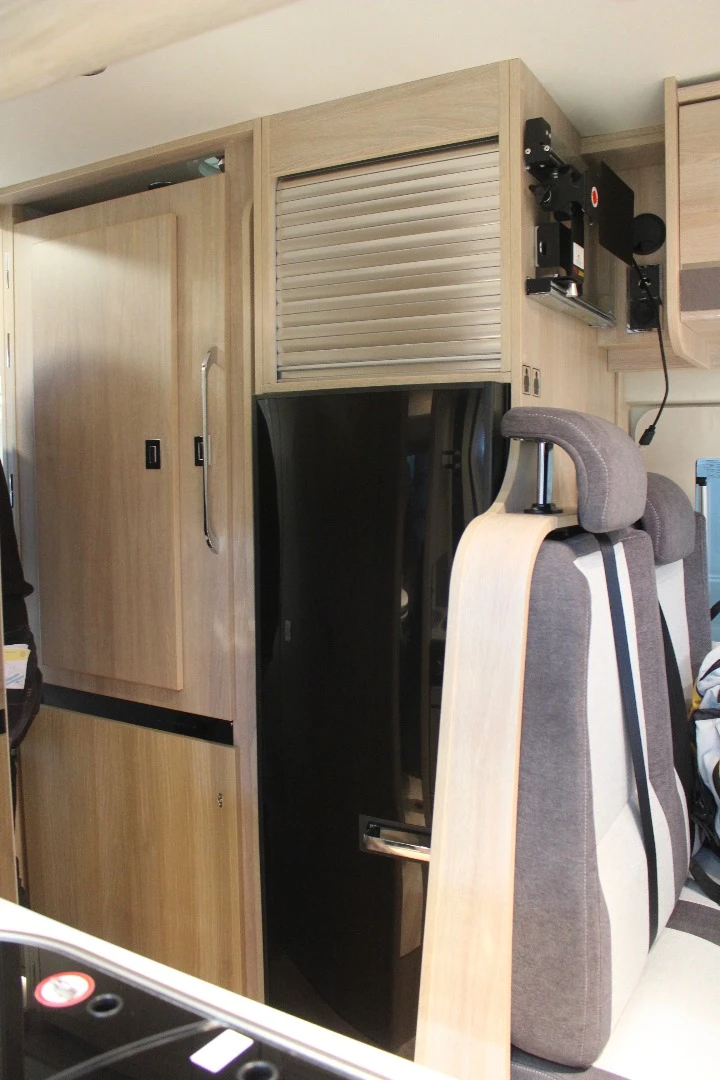 The Rapido V55 fridge is across from the kitchen block, next to the shower compartment