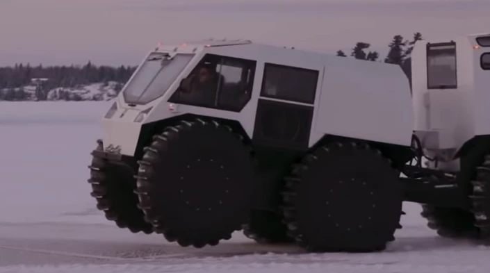 The Sherp Ark lifts its front wheels as it prepares to drop into the icy water ahead