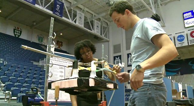 Team members demonstrate how the R-Aide works