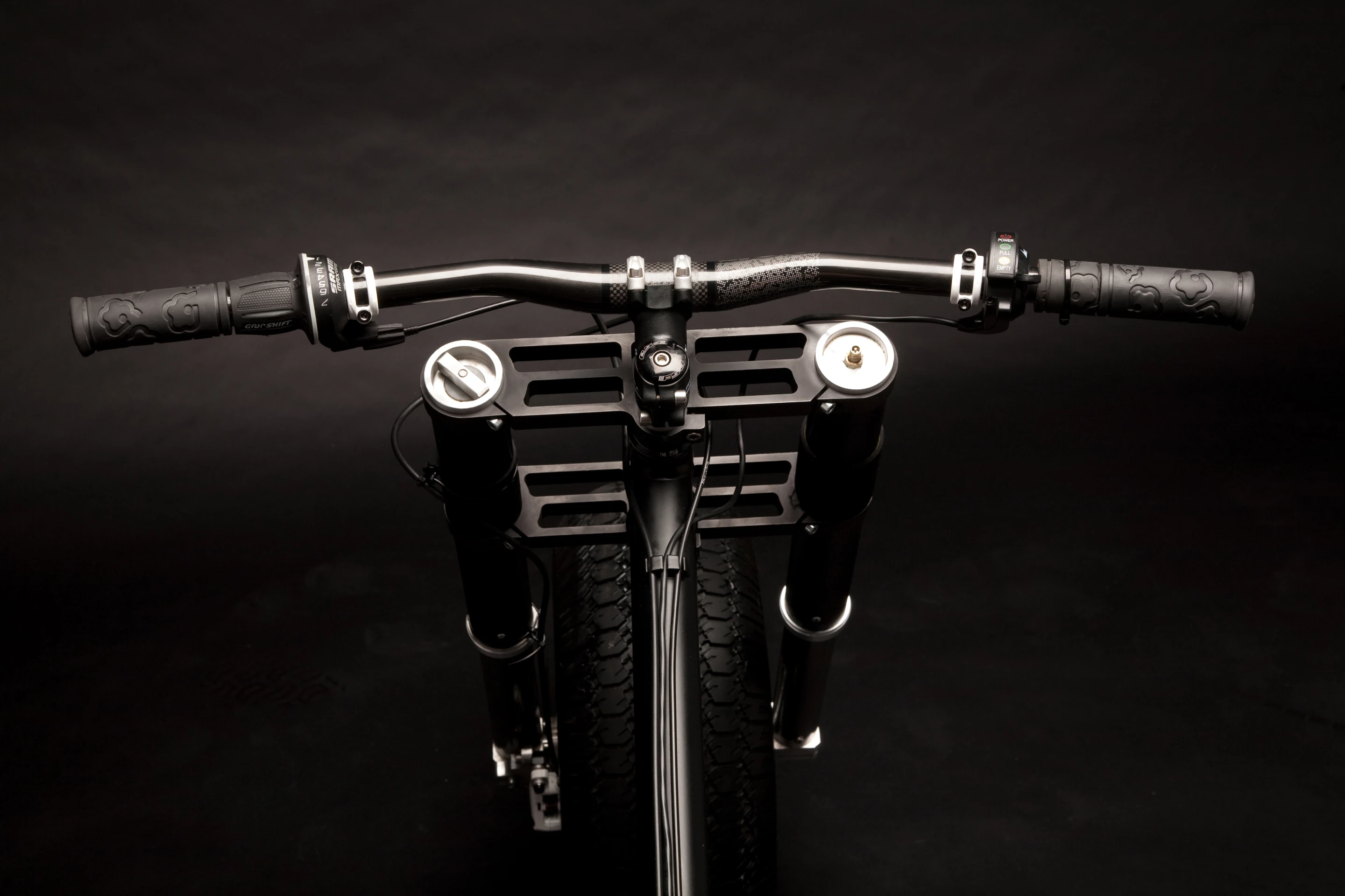 The carbon fiber handlebars is where the throttle and motor controller is mounted
