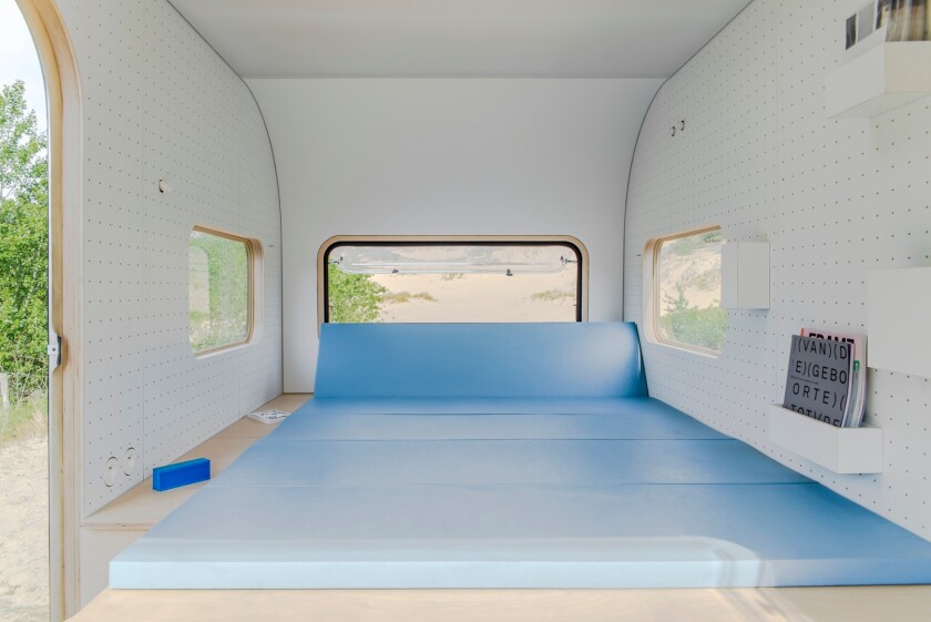 The couch in the dojowheels mobile office can be folded out to form a bed