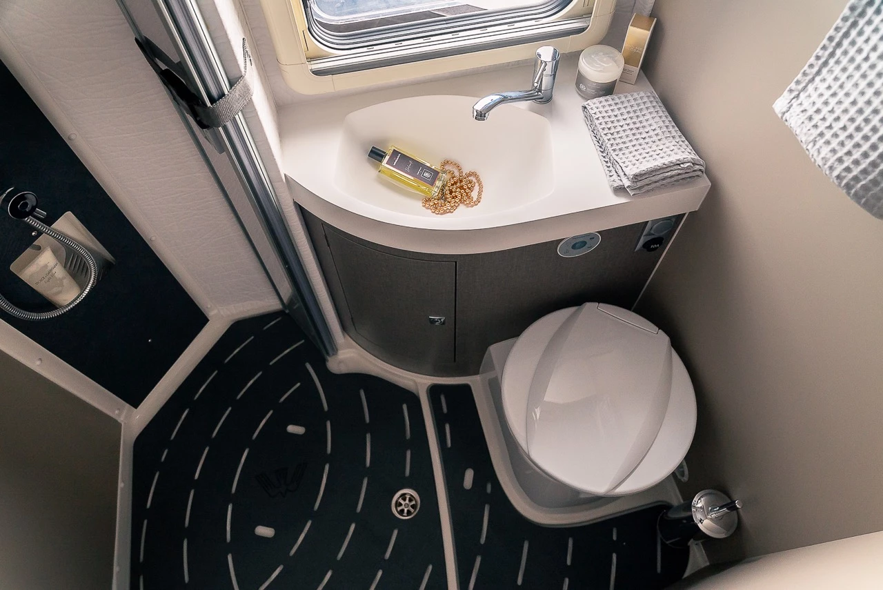 A bit wider than some other wet bathrooms, the Oasi 610 GL bathroom includes a folding shower door that separates shower from vanity sink/toilet