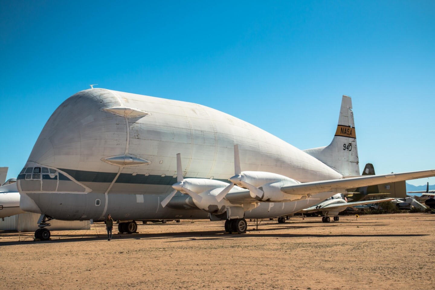 The gob-smacking Aero Spacelines 377-SG Super Guppy is without doubt one of the PIMA Air & Space Museum's most compelling exhibits. It's freakin' huge - note Brianna for scale in our photo. 156 feet across the wings, 46 and a half feet high and 144 feet long with a hinged nose for cargo access, NASA used these things from the mid-60s to carry Saturn rockets around for the Apollo program, among other things.