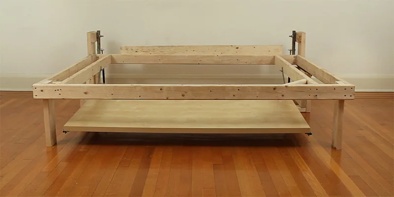 The finished wooden prototype has a 59-inch wide and 29.5-inch deep Vika Amon table top from Ikea and a bed frame measuring 24.5 x 78.5 x 57.5 inches