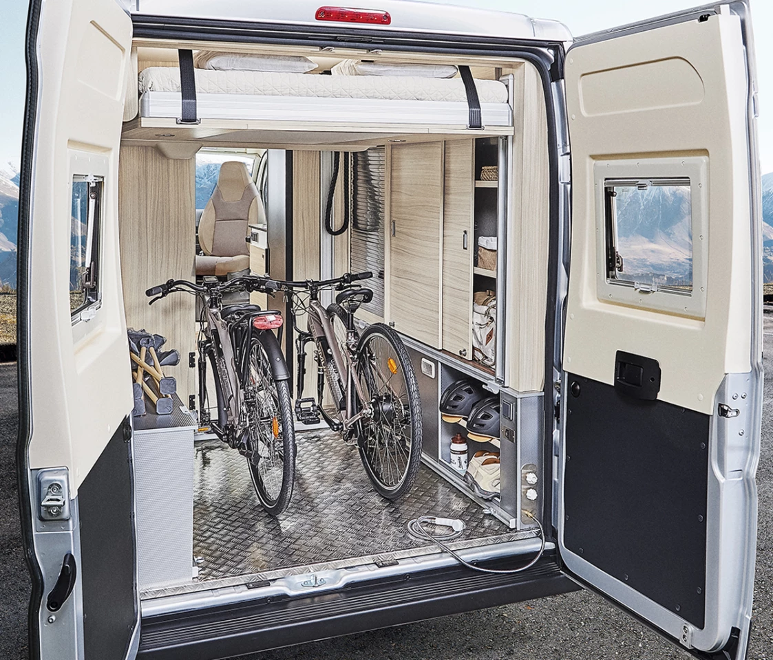 The lower bed removes and the upper bed lifts electrically to clear out a full garage for bikes and other gear
