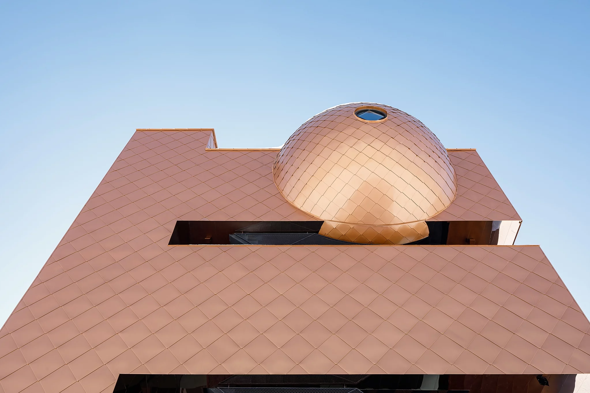 The structure is further enhanced with a Pantheon-inspired sphere located on the top of the building, contributing to its futuristic aesthetic