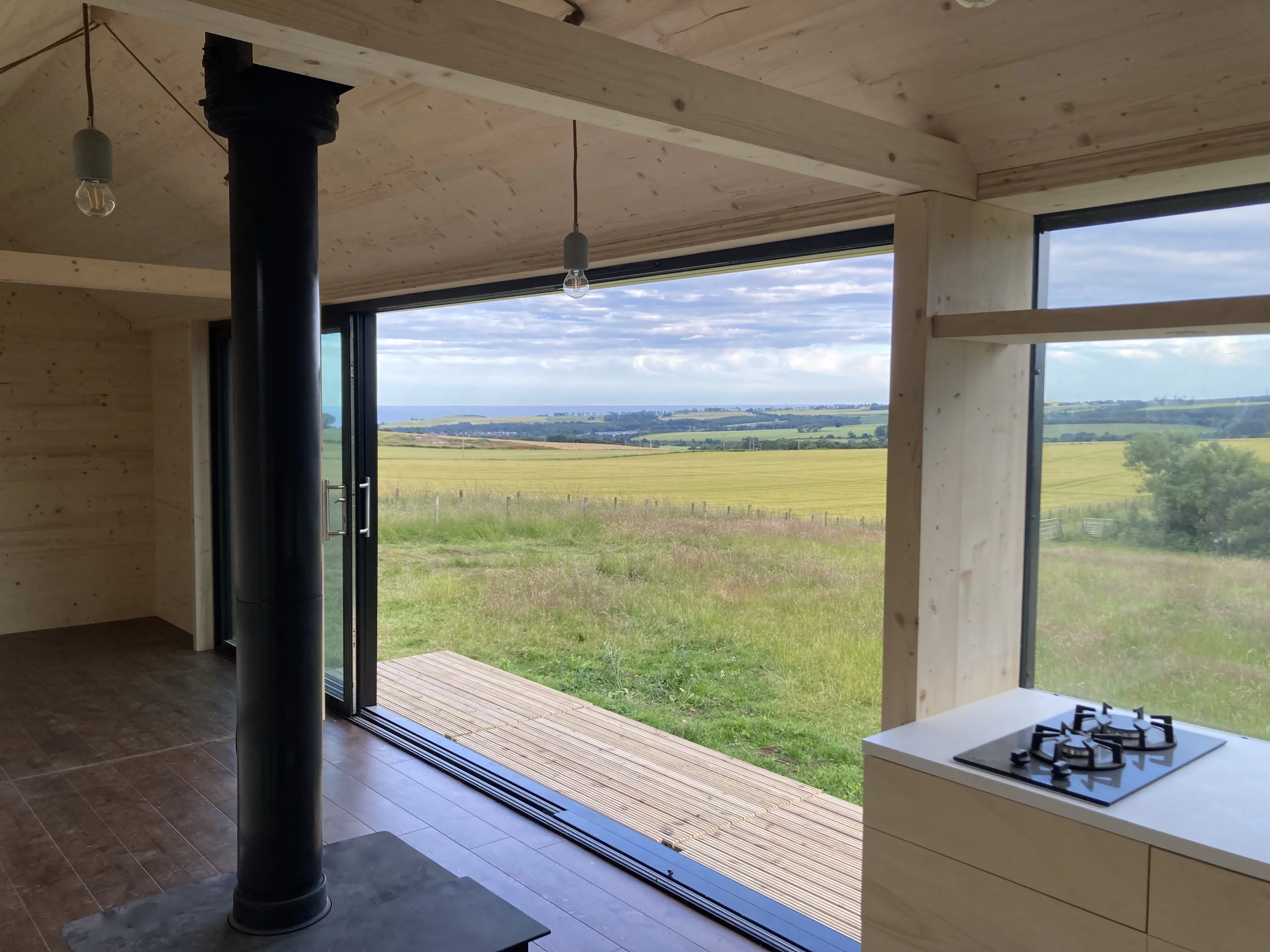 The Long Shed's open interior is warmed by a wood-burning stove