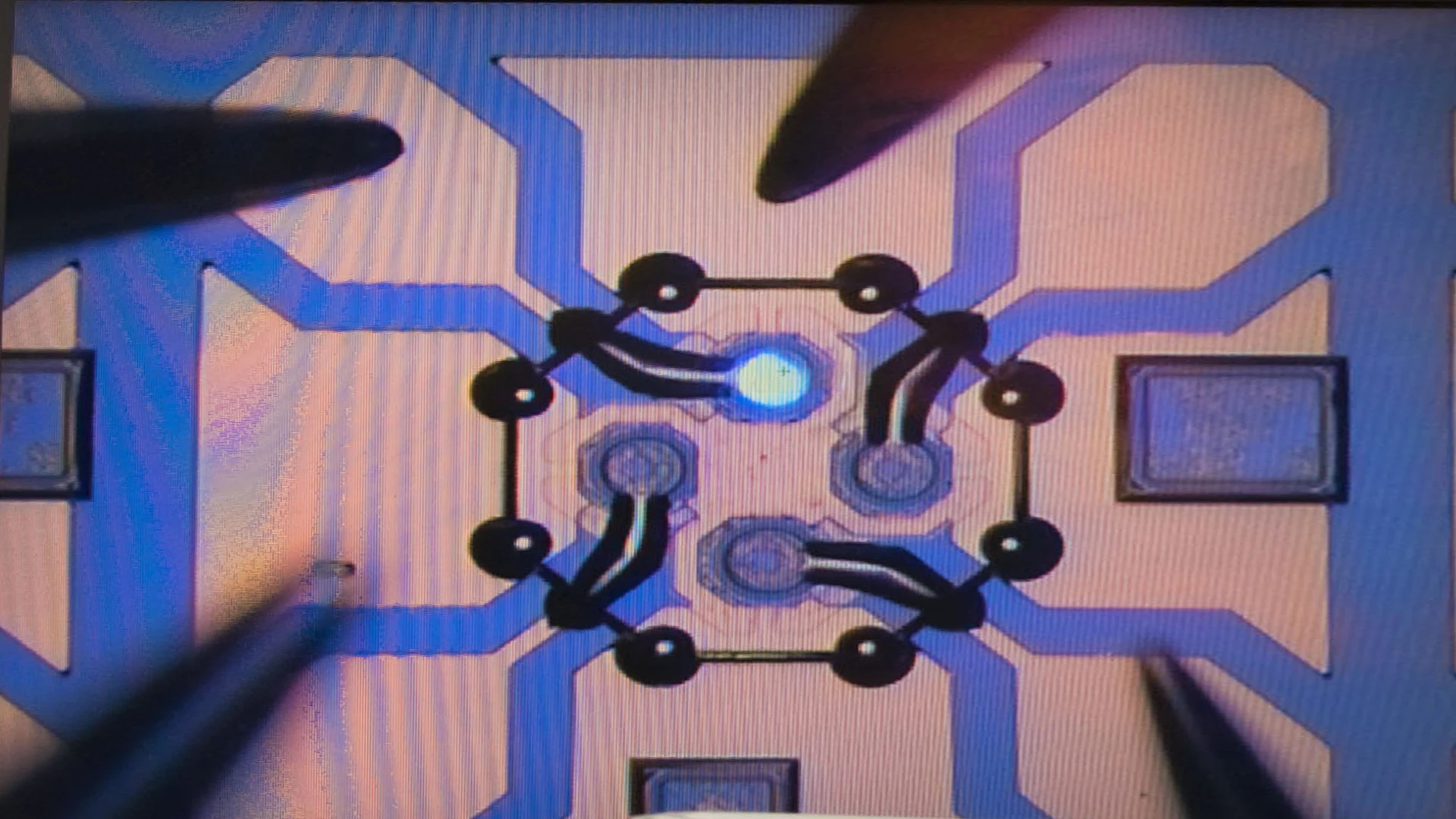 The VCSEL beam (bright spot), seen within the CSAC (Photo: Sandia National Laboratories)