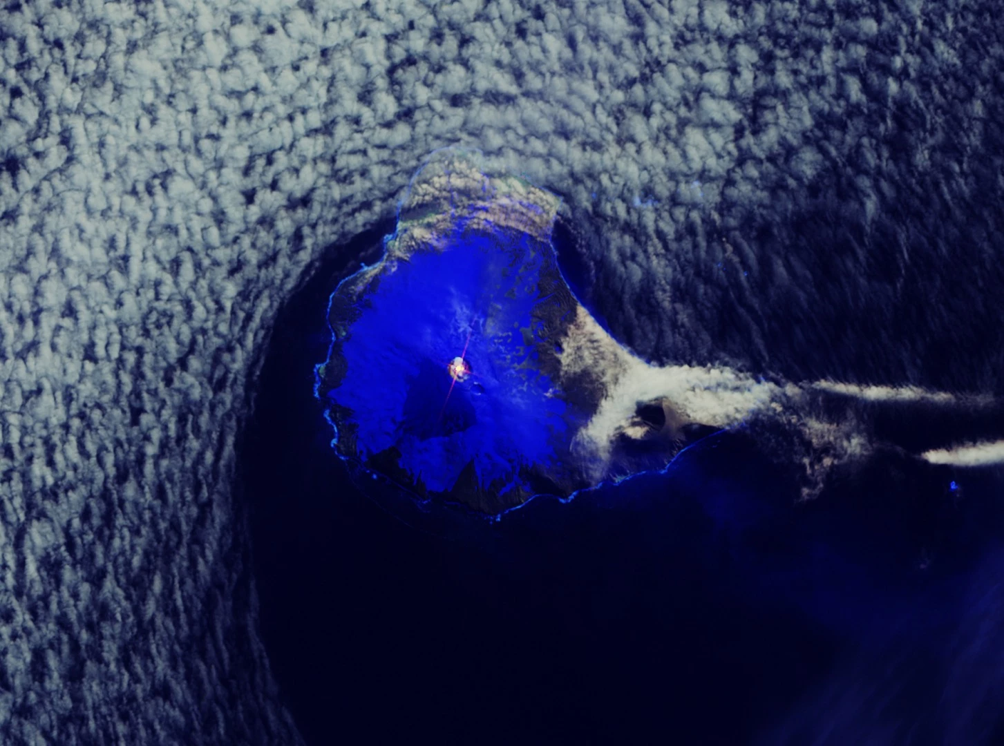 In this image captured by the Copernicus Sentinel-2 mission, a distinct hotspot can be seen in orange in the crater of the volcano