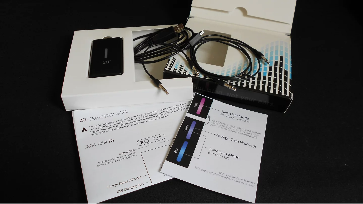 The box contains two audio cables, a USB charging cable, instructions and the Zo 2 personal subwoofer