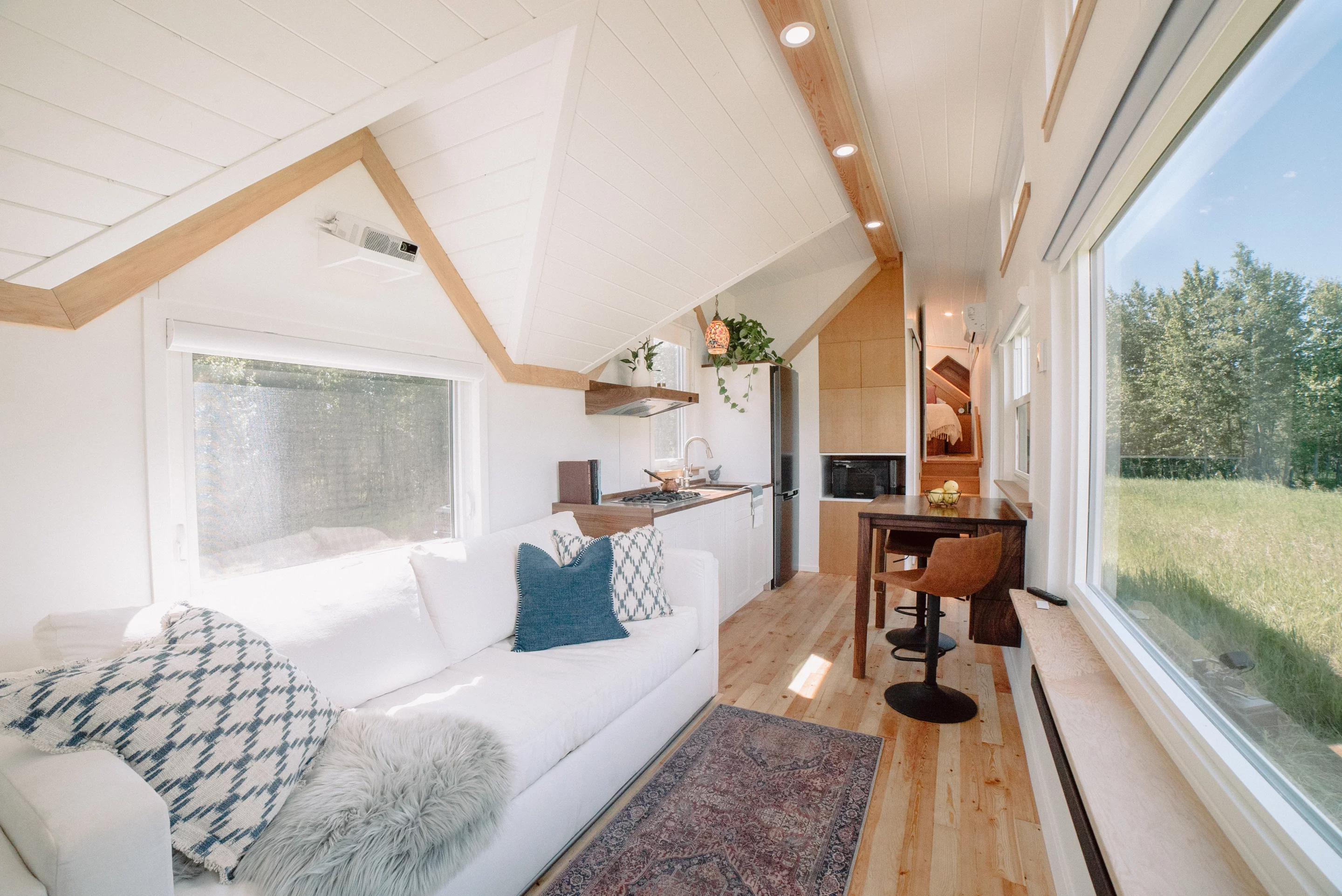 The Macdonald tiny house's interior is airy and light-filled thanks to its generous glazing and fresh, bright decor