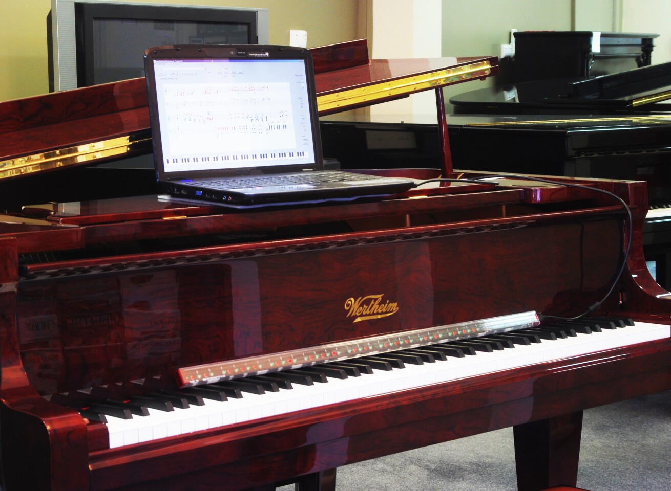 The PianoMaestro learning system on a grand piano