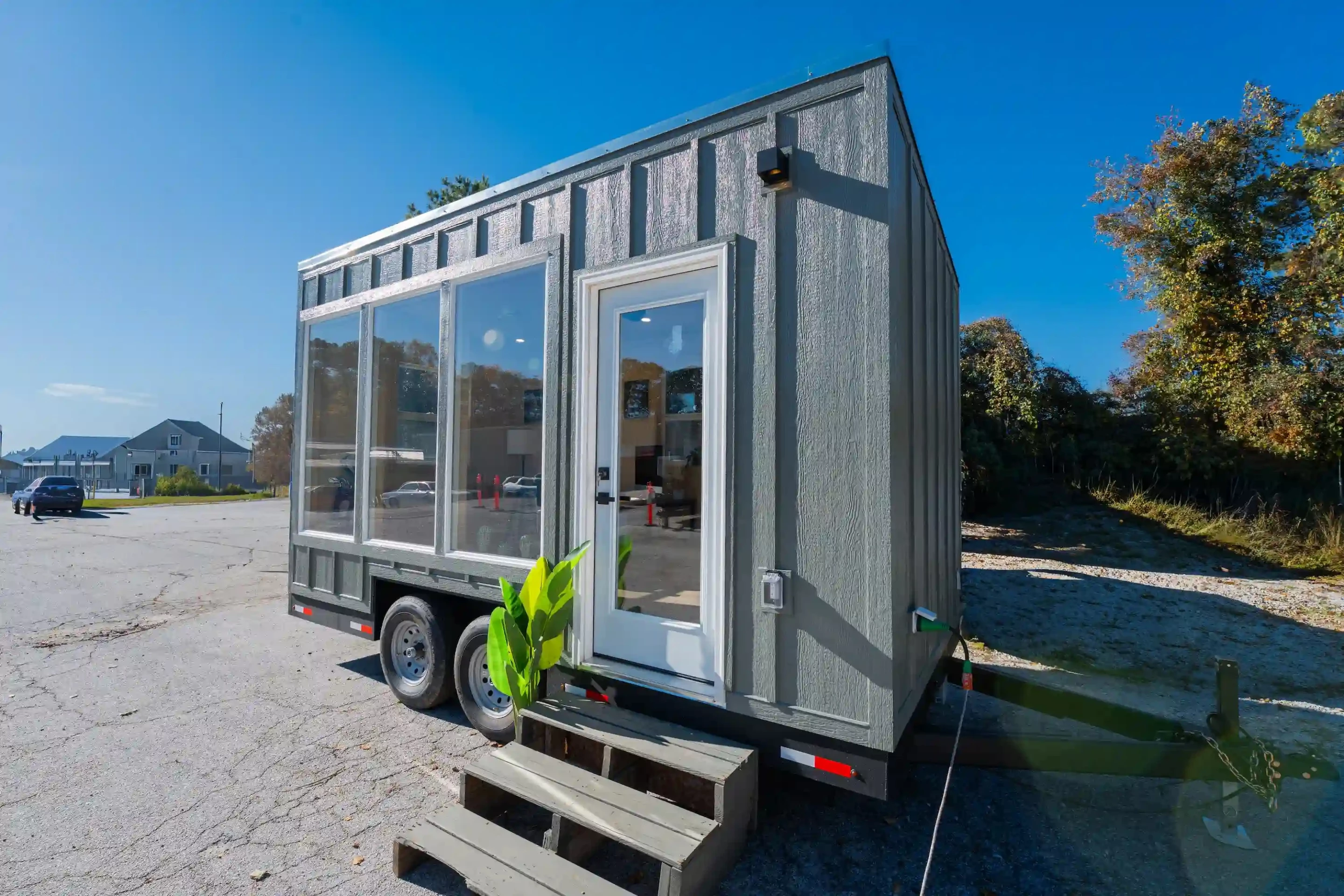 The tiny office features generous glazing and is finished in engineered wood