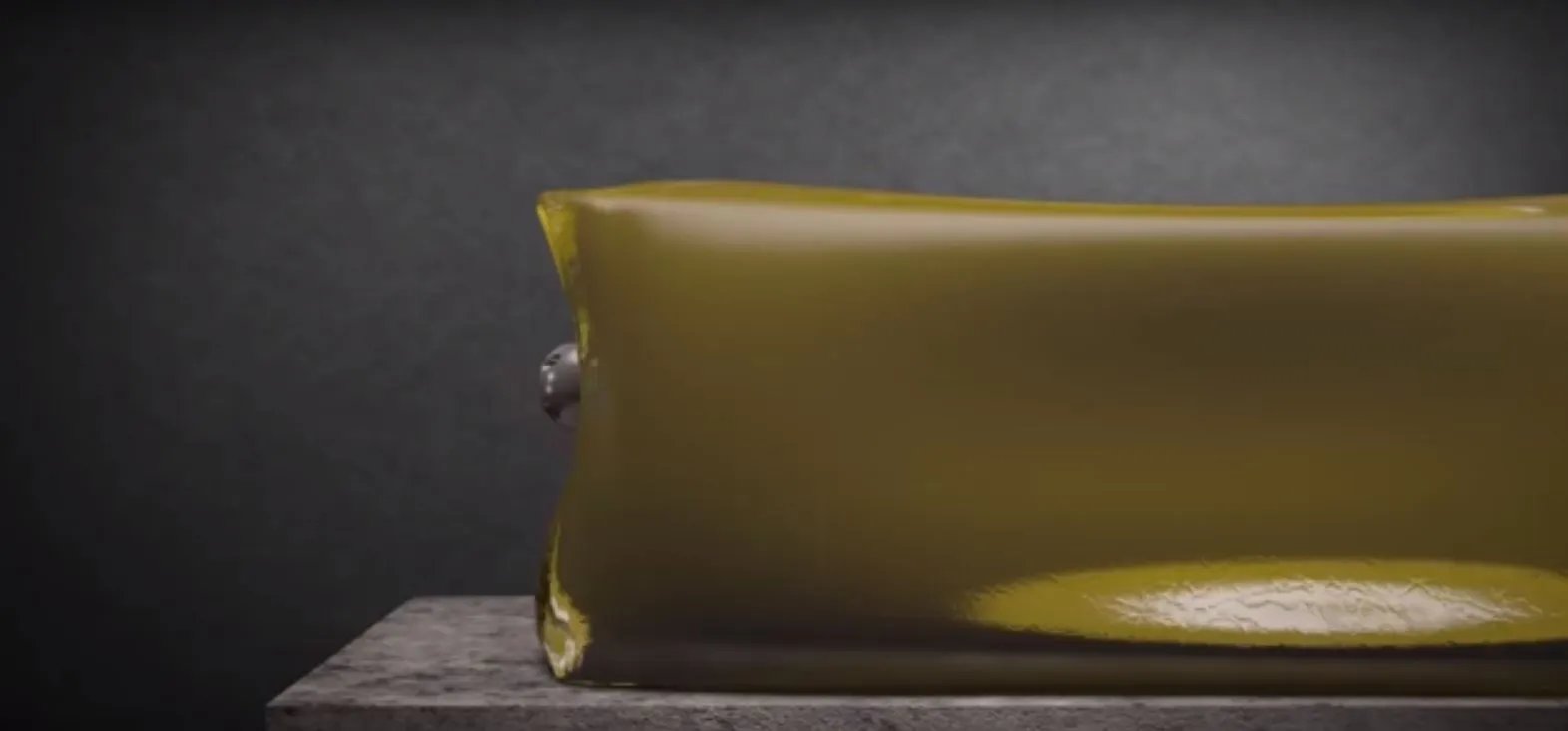 The Alternative striking a block of flesh-like jelly without penetrating