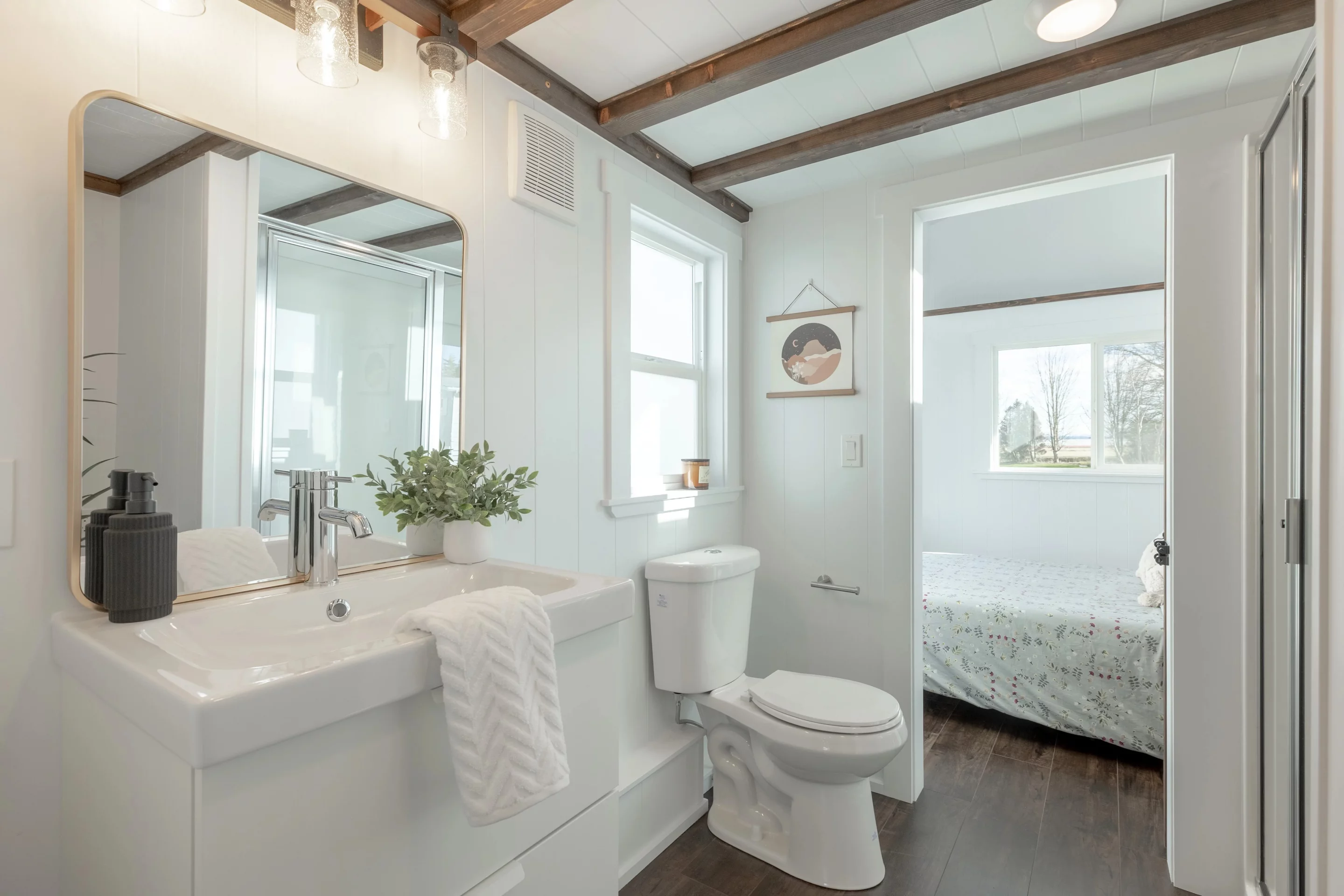 The Violet Edition – Scarlett Loft's bathroom includes a toilet, sink, and shower