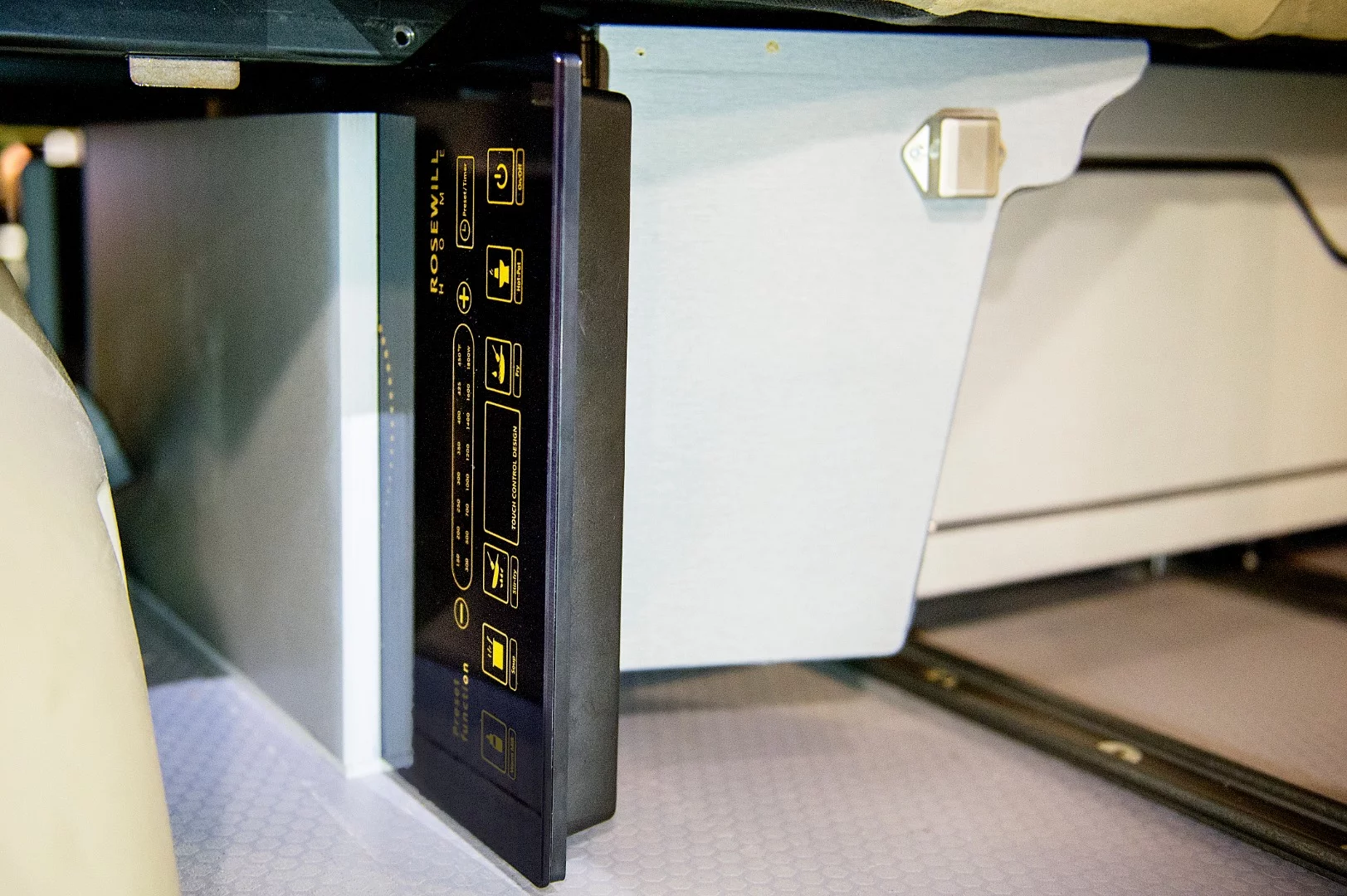 Instead of a full kitchen block, the Eco Explorer has an induction cooker that tucks away below the bench, a removable table and a front console fridge