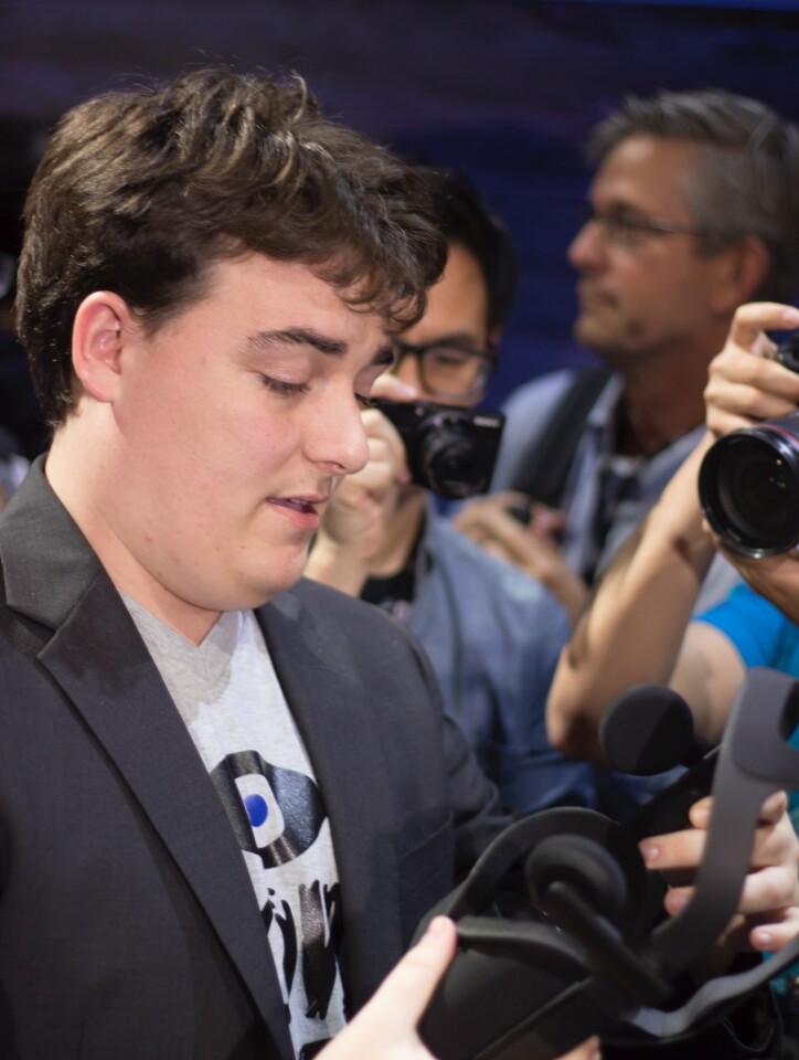 Luckey holding the consumer Rift earlier this year
