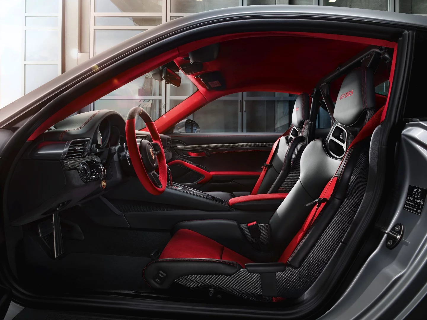 The interior features black leather, red Alcantara and carbon fiber trim