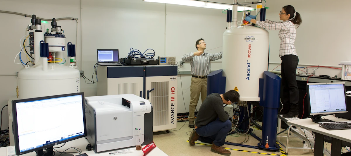 Researchers in the NMR lab, which helped prove experimentally that the new material was an effective conductor of magnesium ions