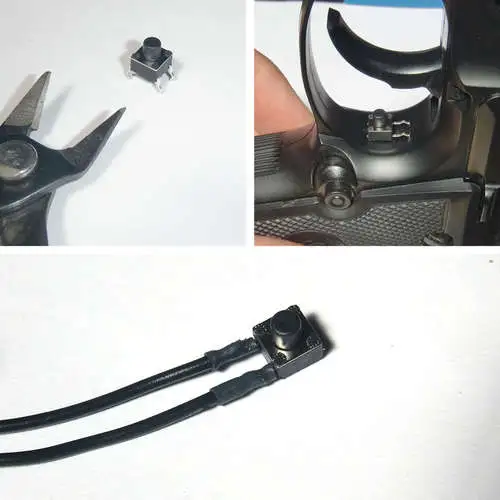 The original toggle switch was replaced with a black momentary switch positioned behind the trigger