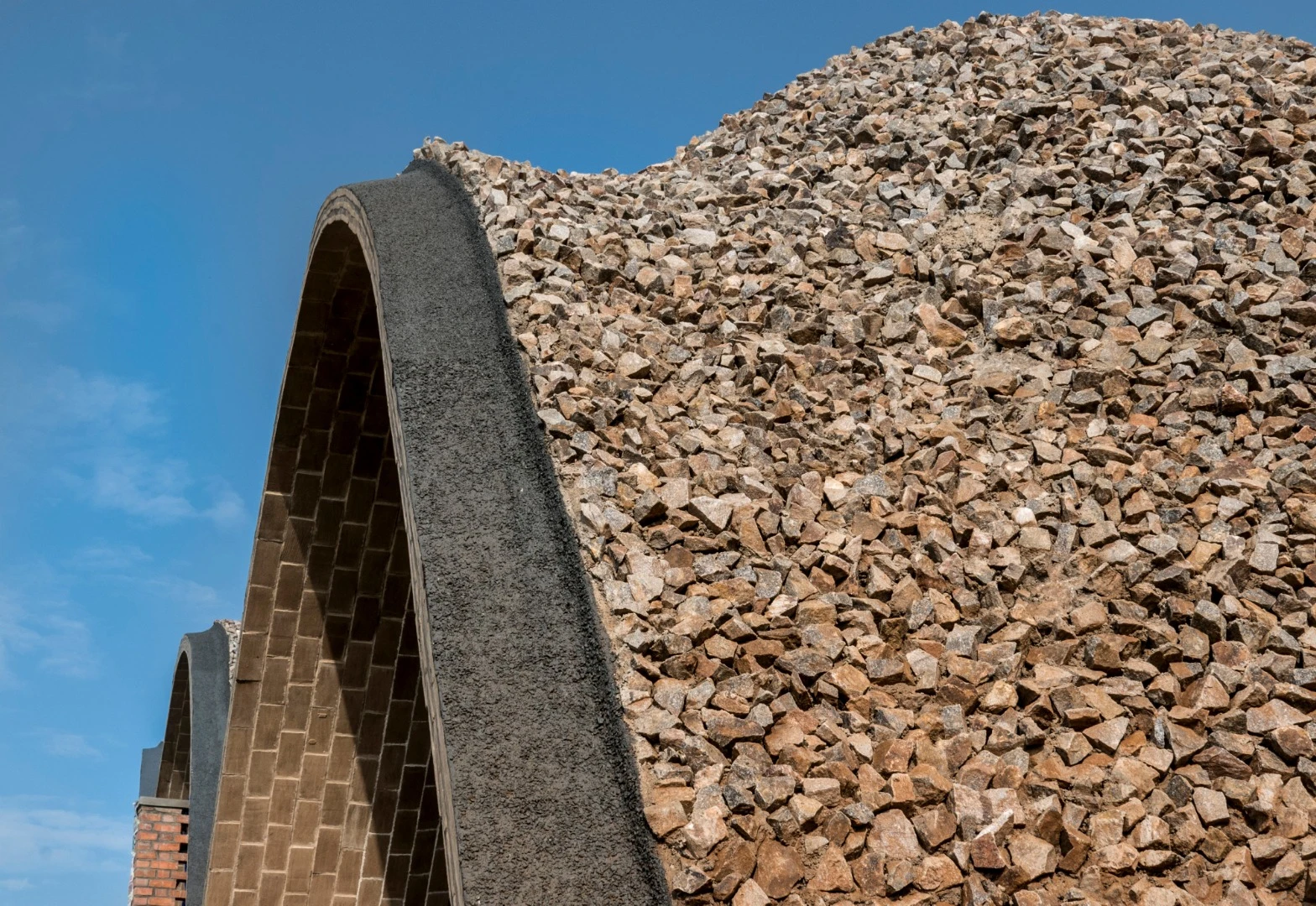 The Rwanda Cricket Stadium is made of air-dried, hand-pressed soil tiles