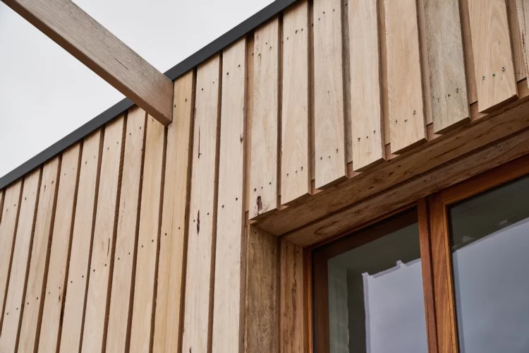 Large floor-to-ceiling glass windows take advantage of the beautiful coastal location and soft neutral colors help the home blend into it's natural landscape