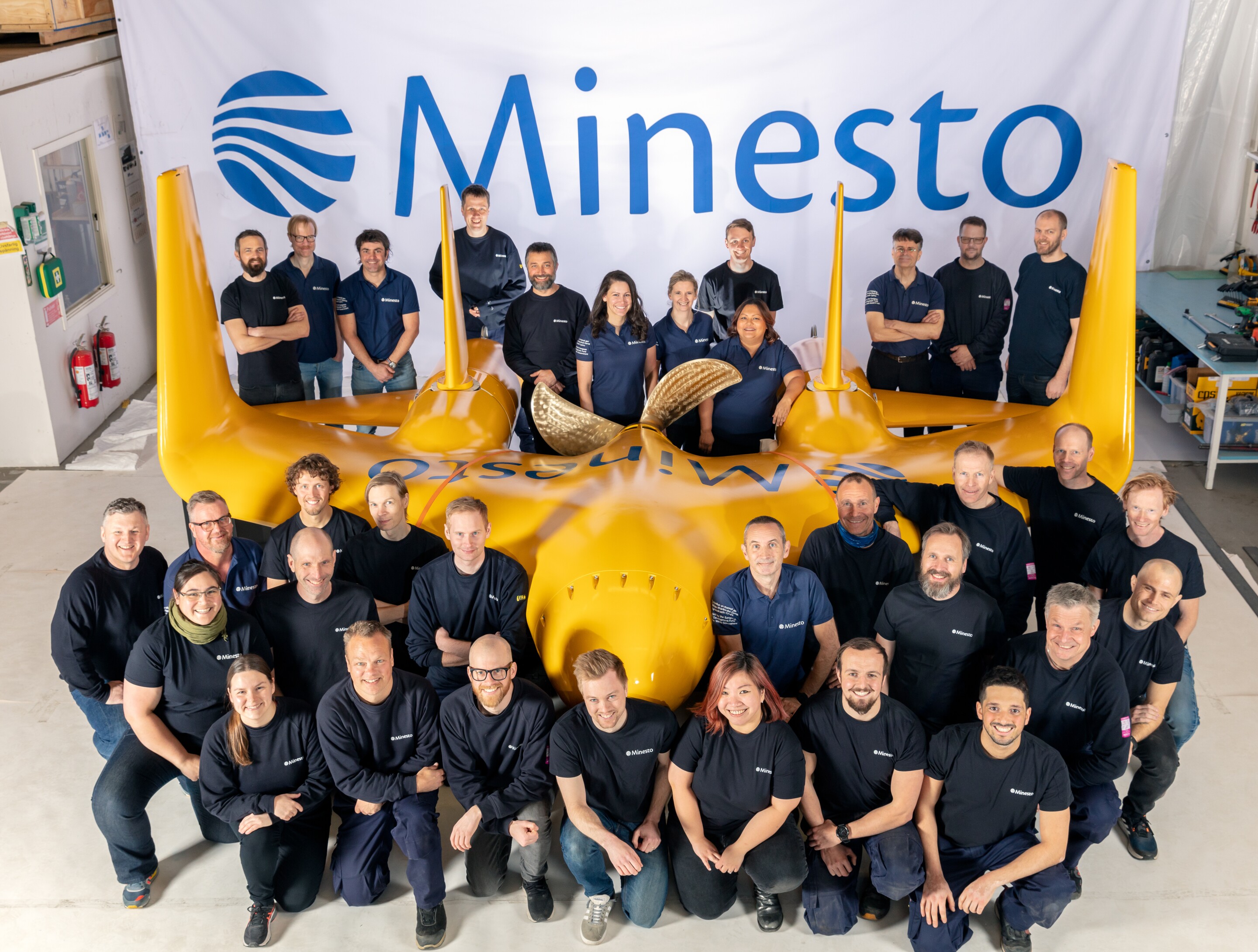 The Minesto team poses with the 1.2 megawatt Dragon 12