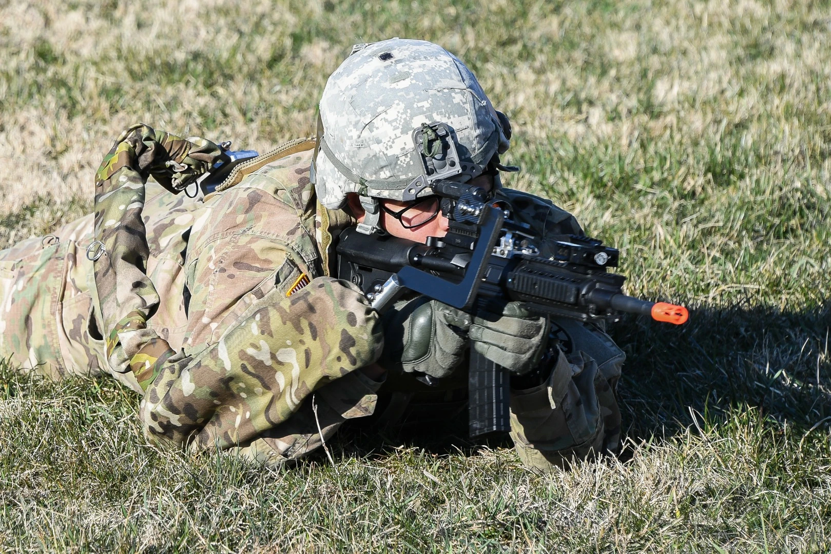 Army Sgt. Michael Zamora assumes a prone fighting position using a prototype Third Arm exoskeleton device