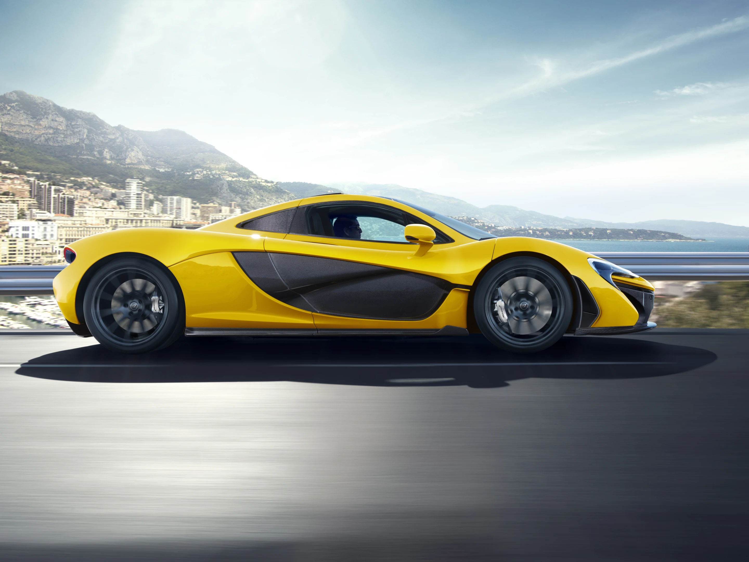 The P1 develops 727 hp through a modified 3.8 liter, twin-turbo V6 while the 176 hp electric motor, located under the customized engine block brings total output up to 903 hp and 664 lb.ft of torque.