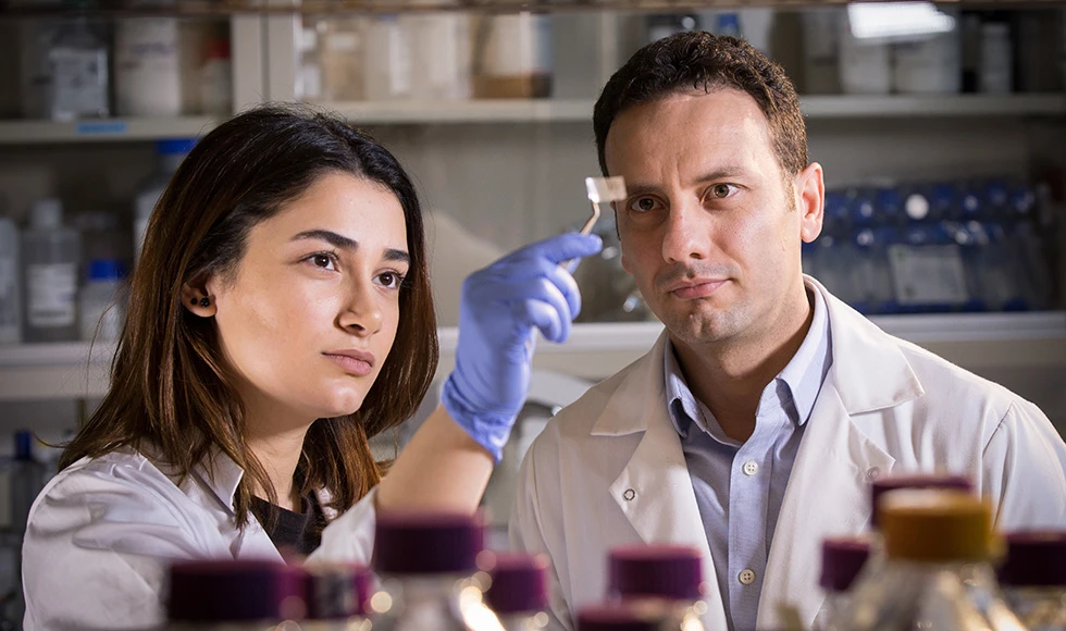 Research assistant Hanie Yousefi (left) and assistant professor Tohid Didar, with a Sentinel Wrap patch