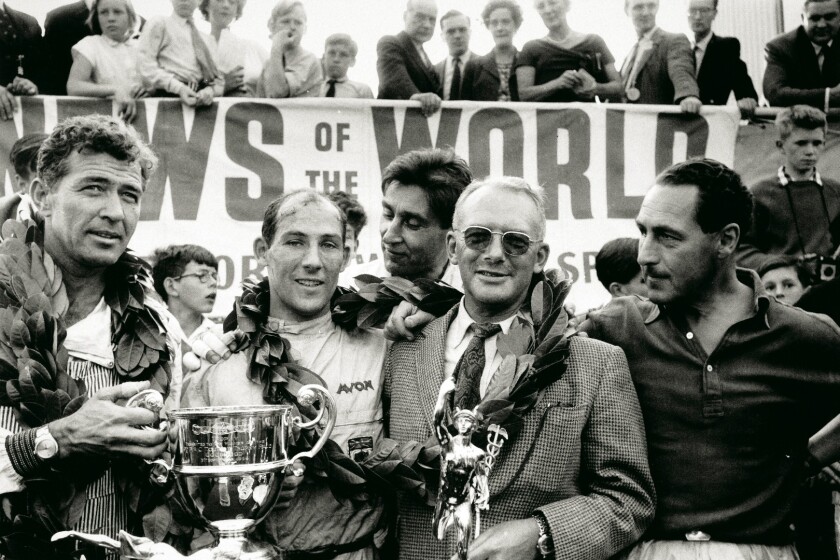 Caroll Shelby, Sterling Moss, David Brown and Roy Salvadori gather on the podium after the 1959 R.A.C. Tourist Trophy on September 5, 1959, the 24th running of the event sponsored by English newspaper, News of the World, and the fifth and final round of the 1959 World Sportscar Championship. In winning the race, Aston Martin emerged from a 3-way contest with Ferrari and Porsche as the 1959 World Champions. It was one of the greatest triumphs for the marque and David Brown.
